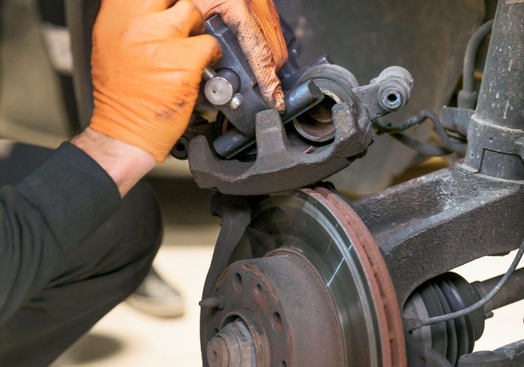 Mobile RV tech replacing worn brake pads on Class C motorhome