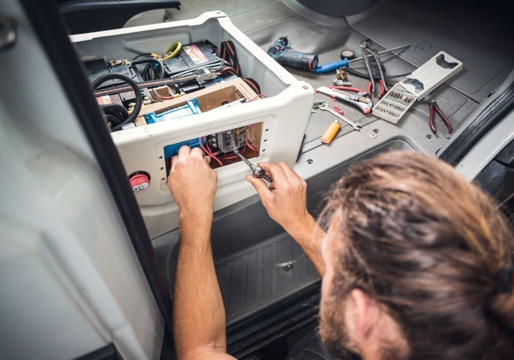 Close-up of RV breaker panel and wiring system being diagnosed on-site
